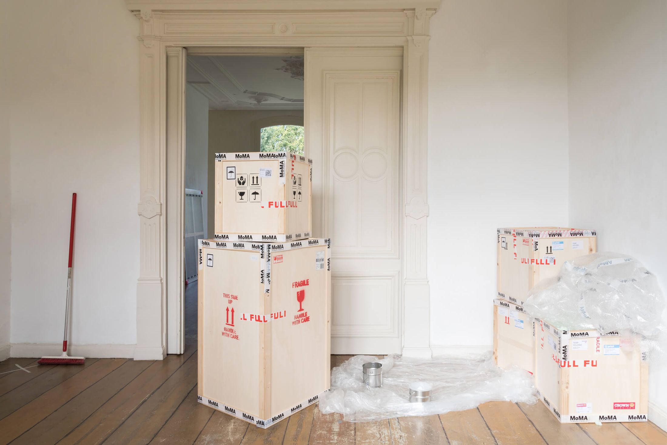 View of the second room of MoMA at the Bank Presents (2018), showing some crates